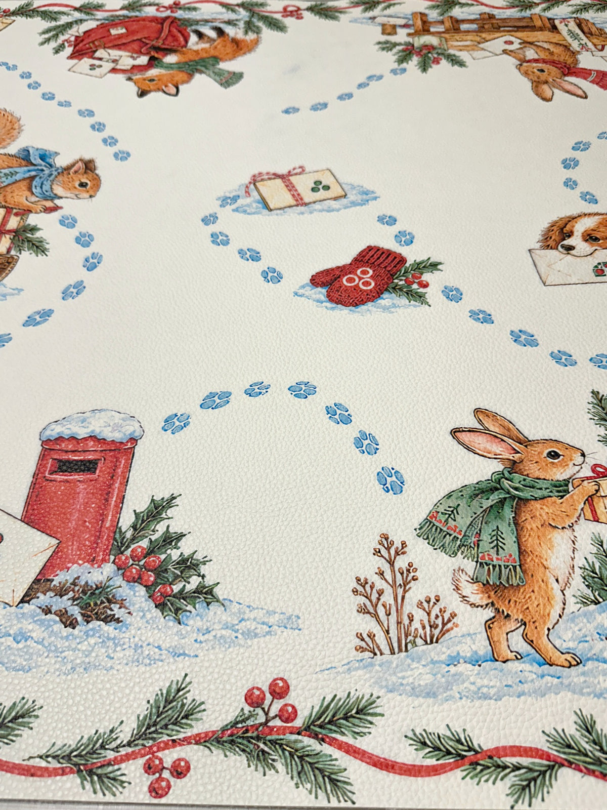 Close-up of a rabbit carrying a gift near a red postbox and blue paw-print trails on the winter animal Mahjong mat