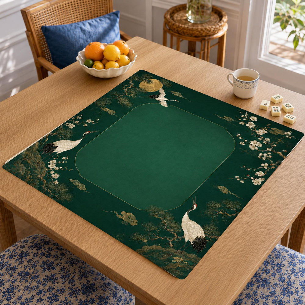 White cranes and delicate flowering branches border a deep emerald green center on this Japanese garden-inspired Mahjong mat.