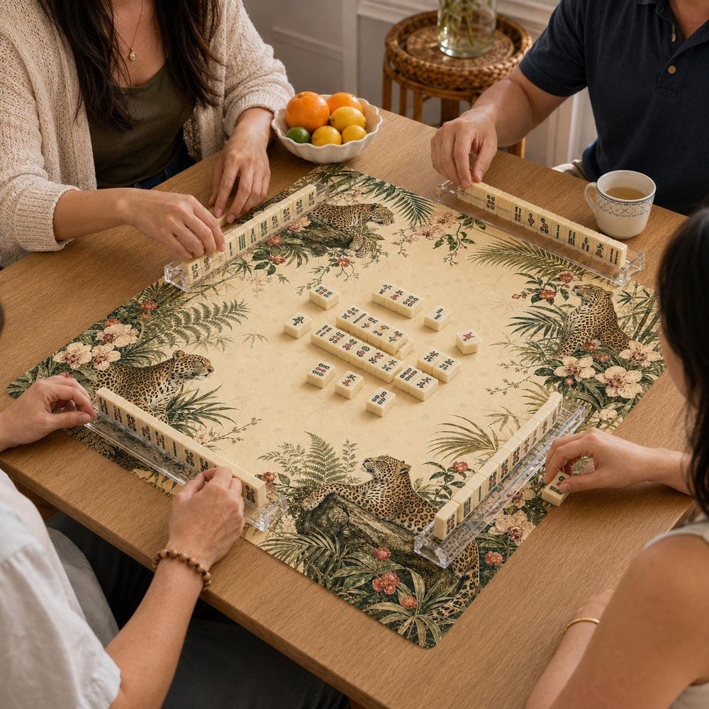 Leopards sit among layered palms and tropical leaves along the border of this cream-centered Conservatory Mahjong mat.