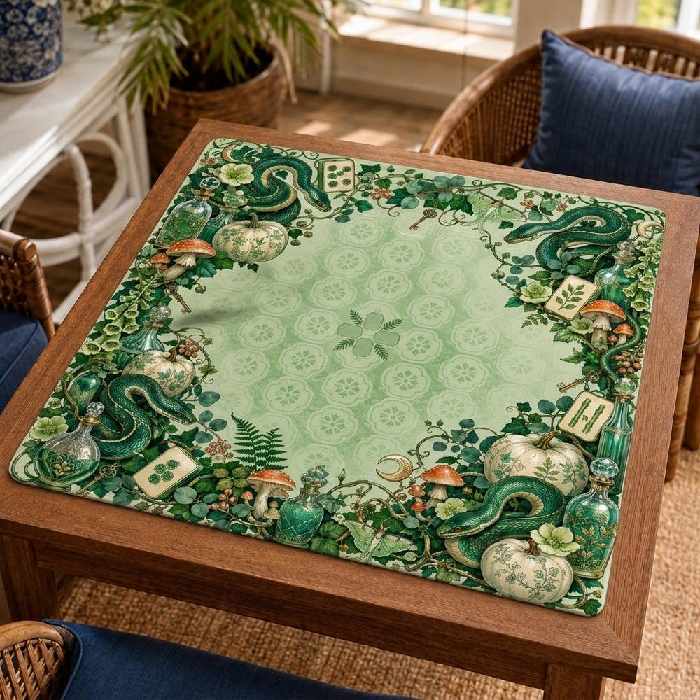 Emerald snakes, apothecary bottles and dense botanical details surround a pale green center on this Halloween Mahjong mat.