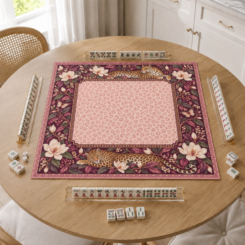 Burgundy vegan leather Mahjong mat with leopards and cream magnolias on a bright kitchen table