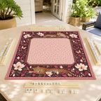 Burgundy vegan leather Mahjong mat with leopards and cream magnolias on a sunlit patio table