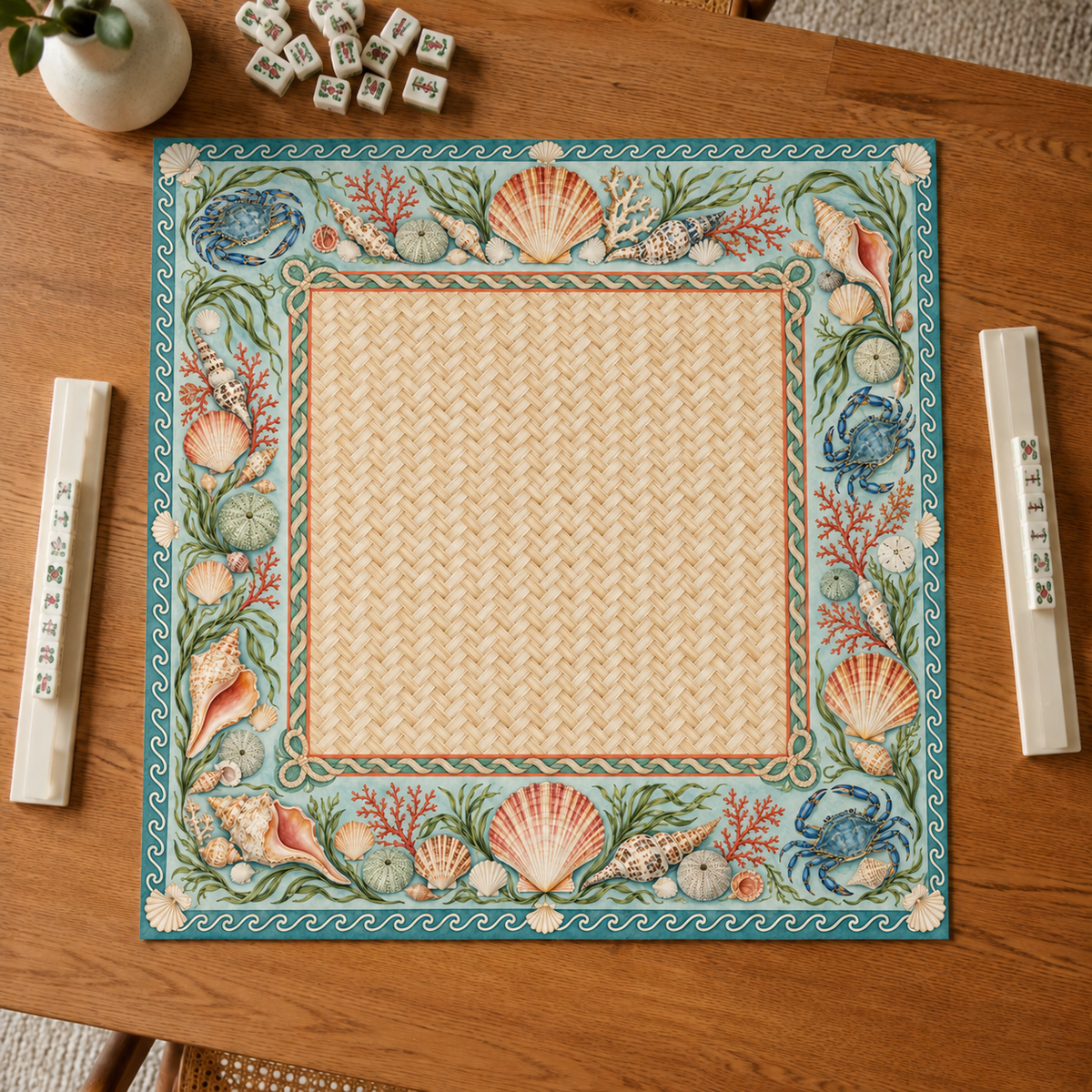Coastal vegan leather Mahjong mat with seashells, blue crabs and coral overhead on an oak table
