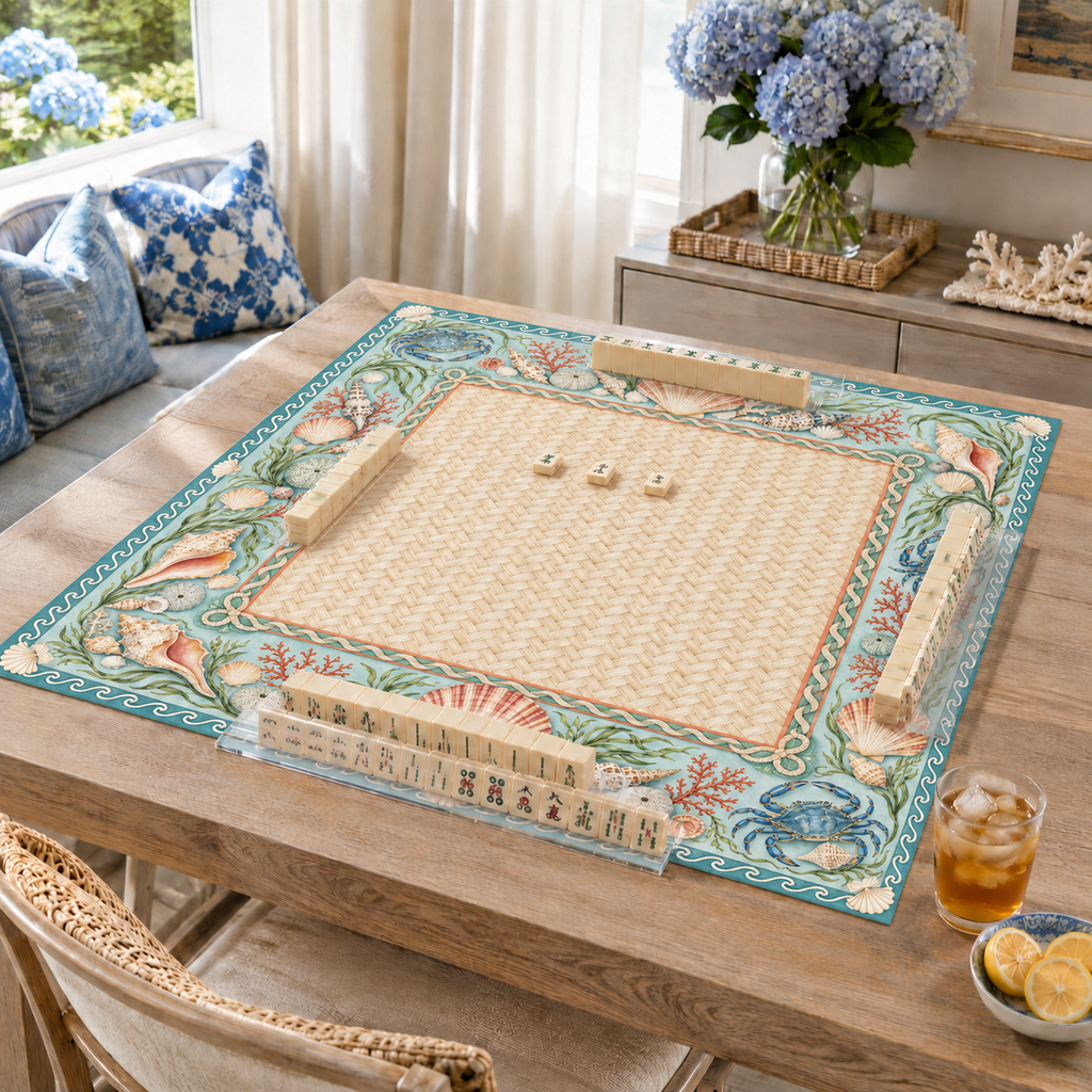 Coastal vegan leather Mahjong mat with seashells, blue crabs and coral on a living room table