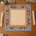 Vegan leather Mahjong mat with pomegranates and a peach checkerboard center overhead on an oak table