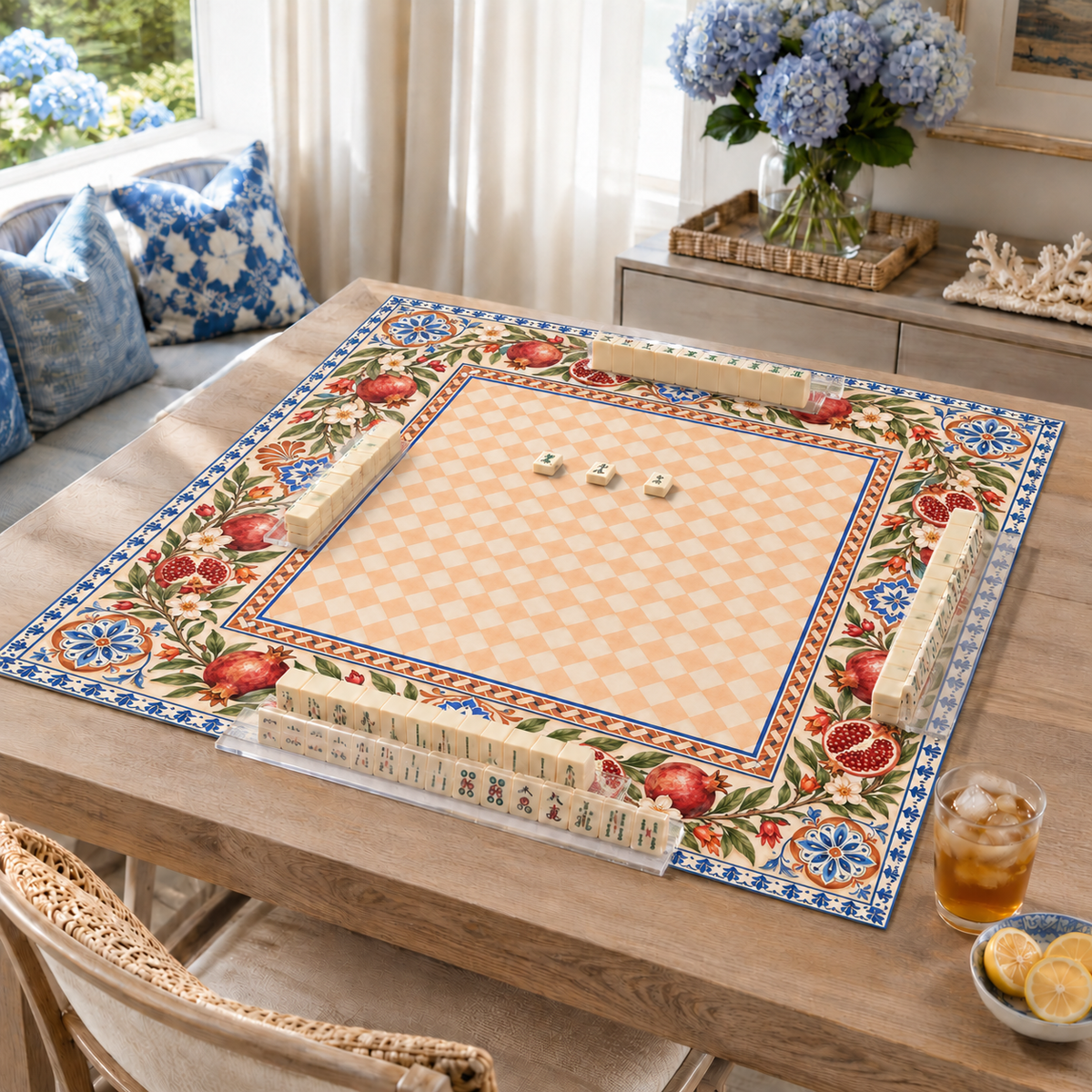 Vegan leather Mahjong mat with pomegranates and a peach checkerboard center on a living room table