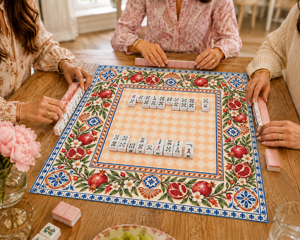 Vegan leather Mahjong mat with pomegranates and a peach checkerboard center with Mahjong tiles during play