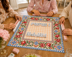 Vegan leather Mahjong mat with pomegranates and a peach checkerboard center with Mahjong tiles during play