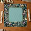 Teal vegan leather Mahjong mat with peacocks, purple irises and Art Nouveau florals overhead on an oak table