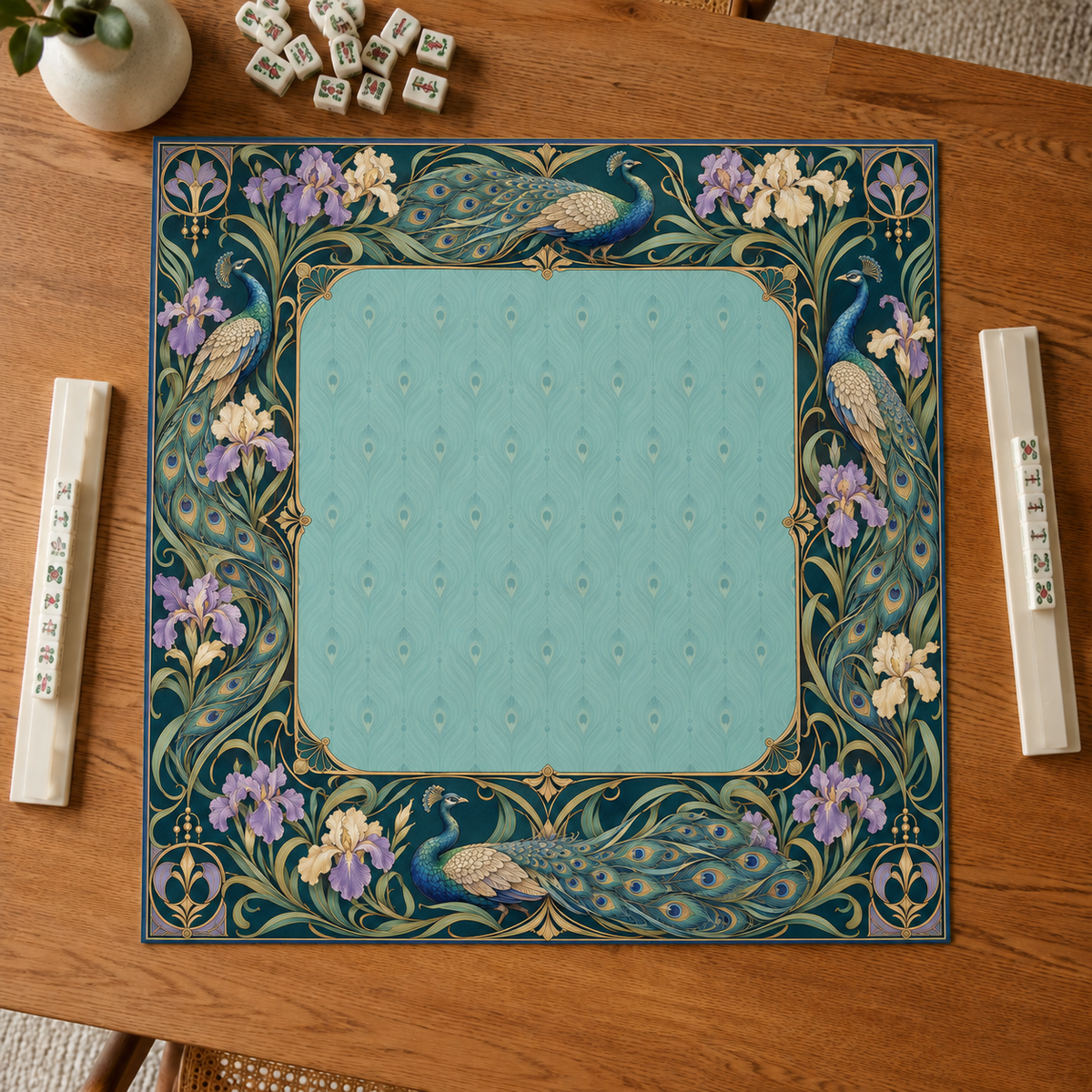 Teal vegan leather Mahjong mat with peacocks, purple irises and Art Nouveau florals overhead on an oak table