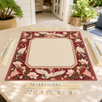 Burgundy Art Deco vegan leather Mahjong mat with white cranes and magnolias on a sunlit patio table