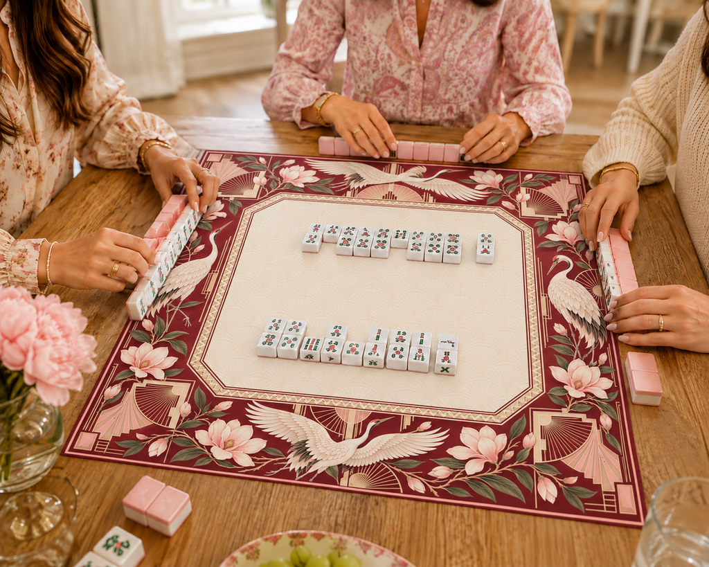 Burgundy Art Deco vegan leather Mahjong mat with white cranes and magnolias with Mahjong tiles during play