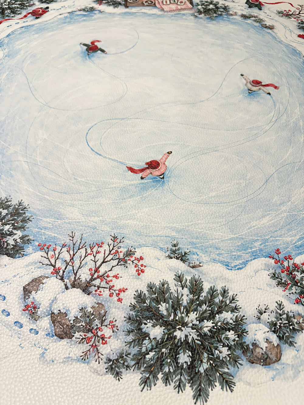 Close-up of ice skaters and curved skating tracks on the pale blue pond of the winter Mahjong mat