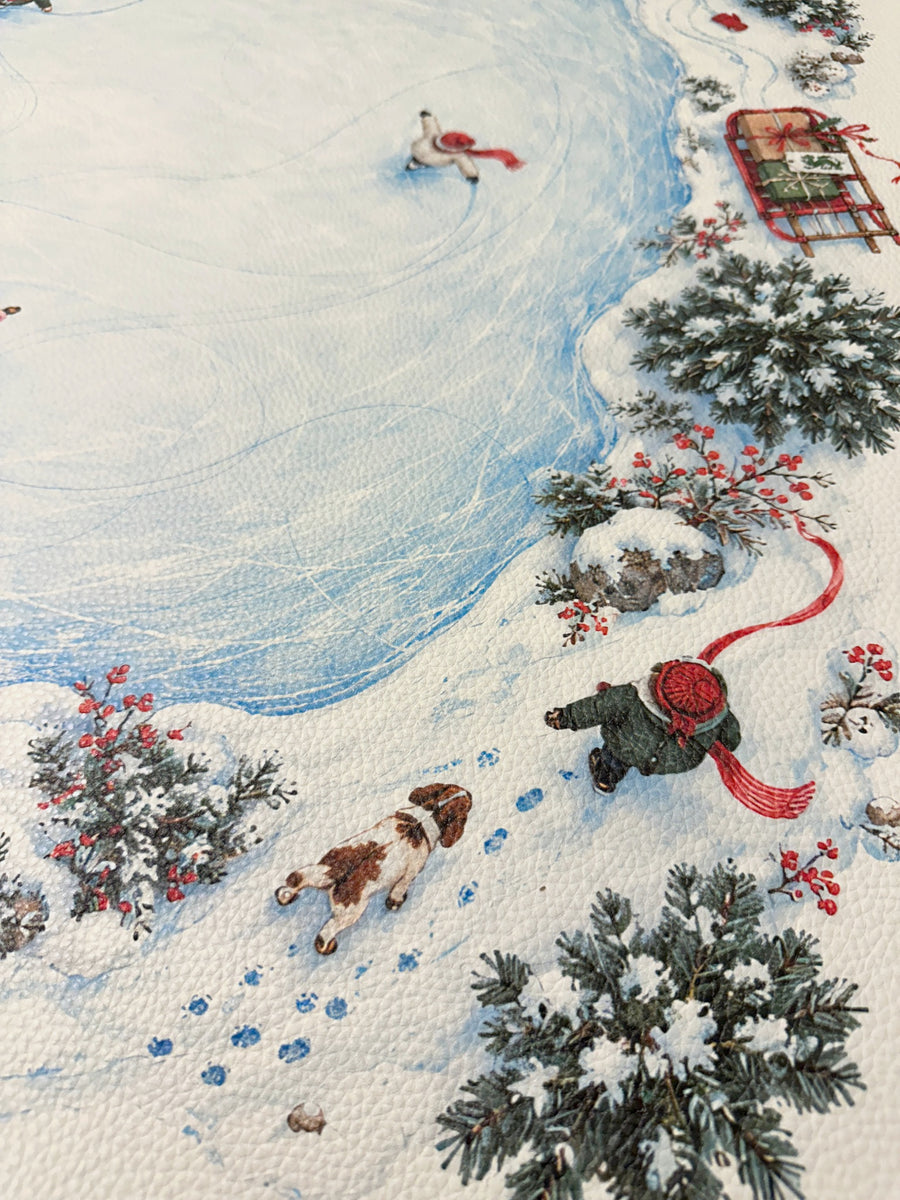 Textured vegan leather surface showing a skater, snowy trees, sled and red winter accessories around the pond