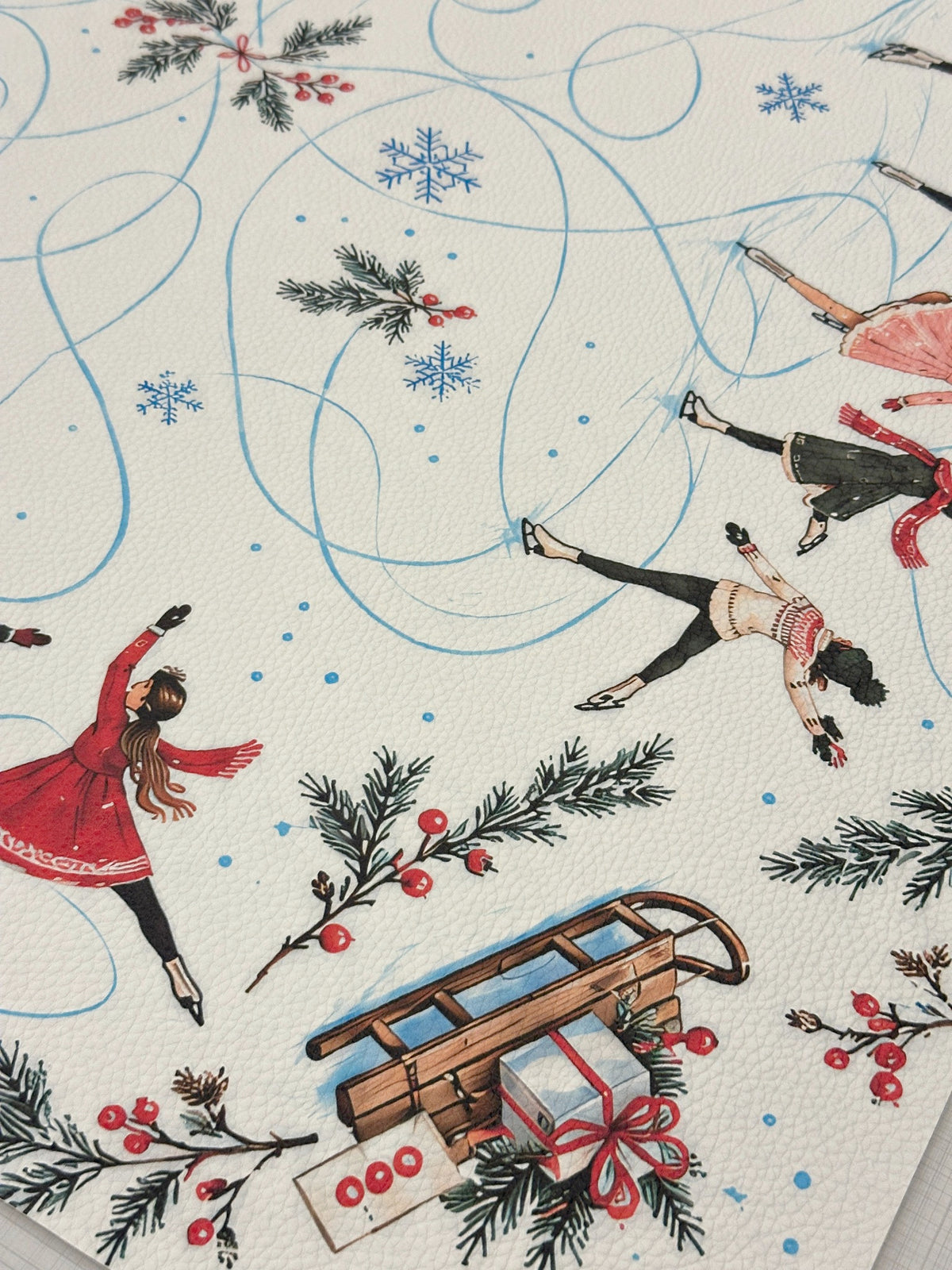 Textured vegan leather surface showing vintage-style skaters, a sled, Mahjong tiles and winter greenery