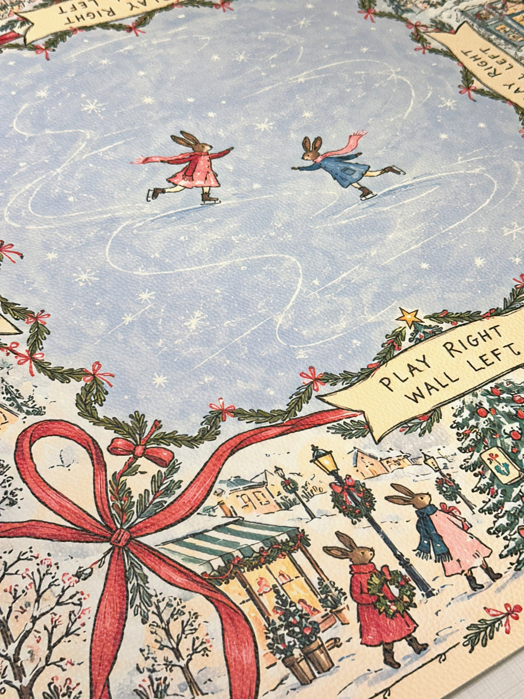 Textured vegan leather surface with skating rabbits, a red bow and snowy village illustrations