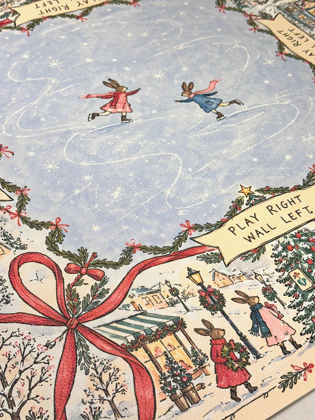 Textured vegan leather surface with skating rabbits, a red bow and snowy village illustrations