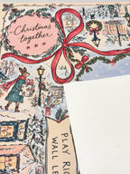 Cream suede backing beside the winter rabbit mat with Christmas together lettering, a red bow and snowy village details