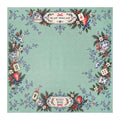 Green Christmas Mahjong mat with Merry Mahj lettering, blue-and-white ceramics, red ornaments and festive greenery