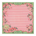 Pink and green Christmas Mahjong mat with a striped center, scalloped border, red bows and printed Charleston reminders