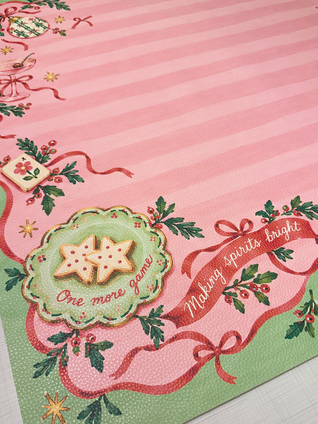 Textured vegan leather surface with pink stripes, Mahjong tile cookies, red ribbons and a green scalloped border