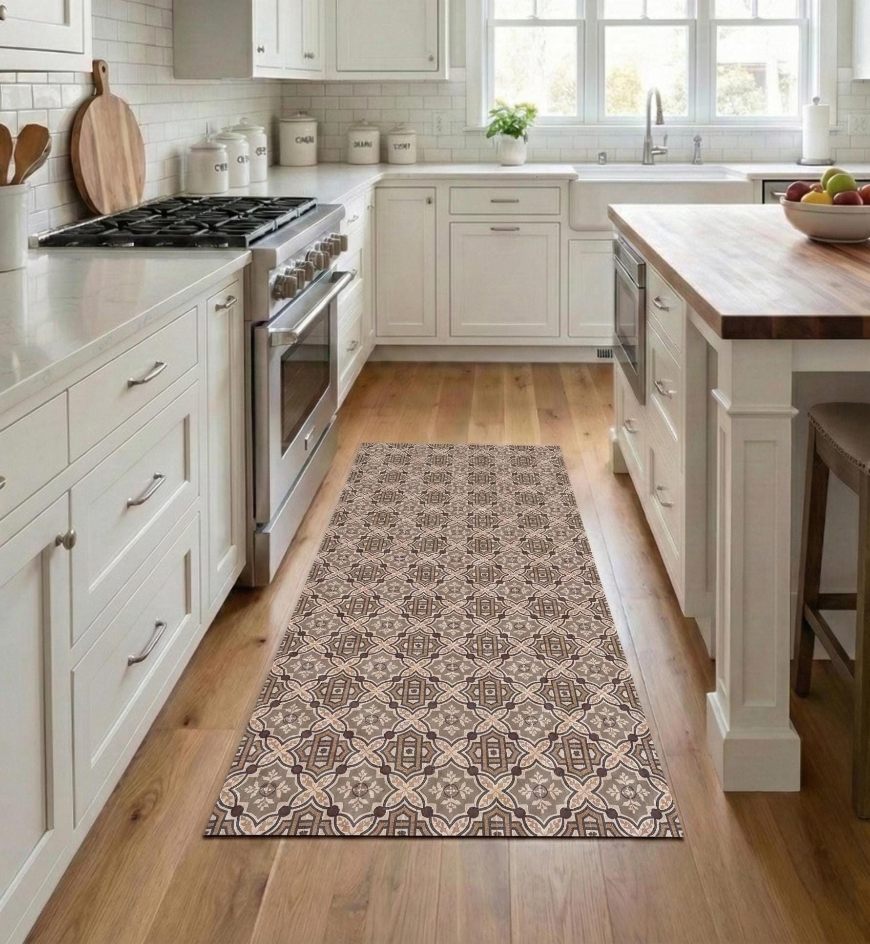 May include: A rectangular kitchen rug with a repeating geometric pattern in shades of brown, beige, and gray. The rug is placed on a hardwood floor in a kitchen setting, adding a decorative element to the space.