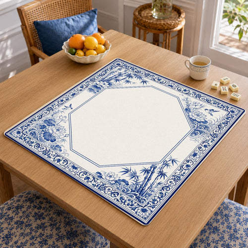An indigo blue botanical border surrounds a pale, angular central panel on this blue-and-white porcelain-inspired Mahjong mat.