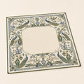 Blue peacocks, flowers and porcelain-inspired motifs form an ornate border around the cream center of this chinoiserie Mahjong mat.