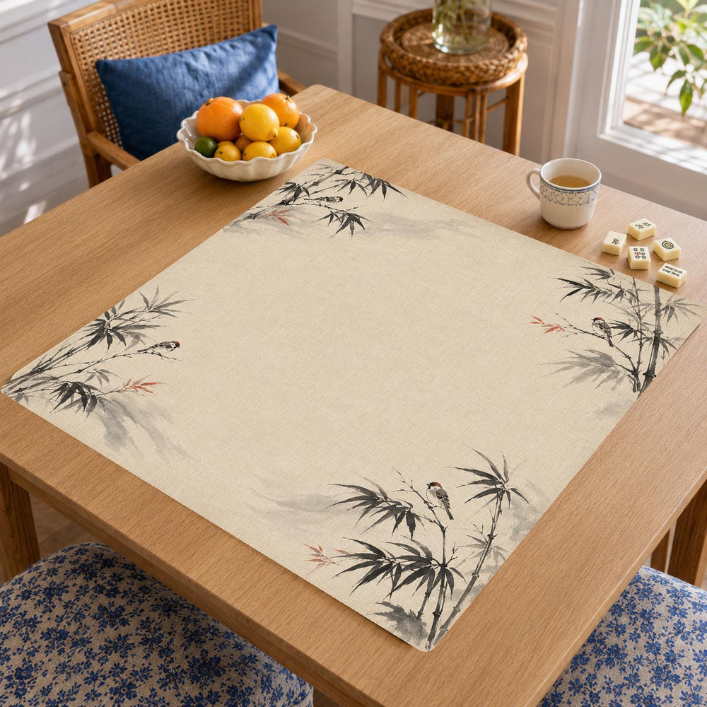 Fine black bamboo stems and small bird illustrations leave an open cream center on this Japanese ink-inspired Mahjong mat.
