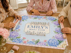 Blue and lavender hydrangeas and a pink gingham border surround a personalized Mahj Club panel on a Mahjong mat.