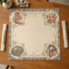 A floral cowboy boot, peony, patterned scarf and concho motifs decorate the corners of a cream Western Mahjong mat.