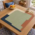 A sage green center meets broad navy, cream and terracotta geometric blocks on this minimalist, mid-century-inspired Mahjong mat.