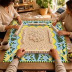 Mahjong game in progress on the Christmas mat with cream patterned center, pale blue border, yellow striped bows and Christmas trees