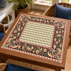 Christmas Mahjong mat with pale green harlequin center, vintage ornaments, decorative masks and pink scrollwork on a wooden game table